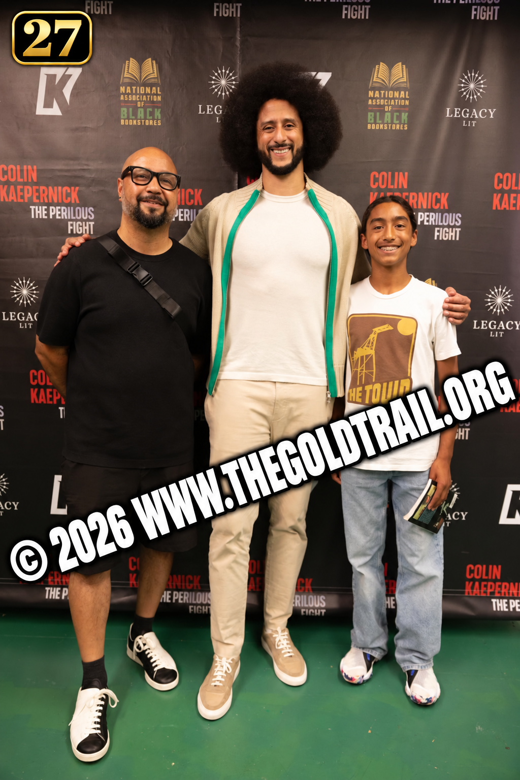 Guests posing at the Kaepernick event backdrop